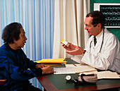 GP doctor discusses drug prescription with woman