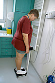 An overweight boy being weighed