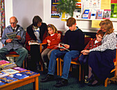 Adults and children sit in doctor's waiting room