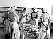 Student nurses,overseen by a Sister