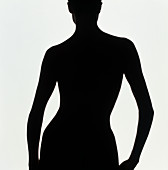 Silhouette of a naked standing woman (back view)