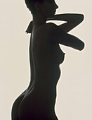 Silhouette of standing woman's torso (side view)