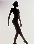 Silhouette of a standing naked woman (side view)