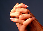 Close-up of the interlocked fingers of a woman