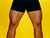 View of the well-muscled legs of male bodybuilder