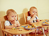 Twin boys eating