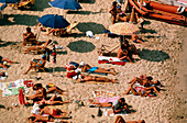 People sunbathing on a Sardinian beach