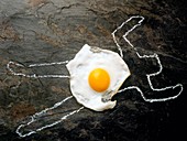 Cholesterol death: outline of body and a fried egg