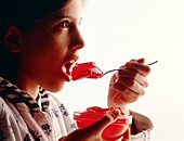 Young girl eating jelly