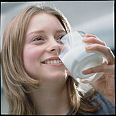 Teenage girl drinking a glass of milk