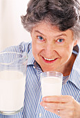 Elderly woman drinking milk