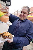 Obese man eating food