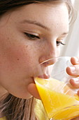 Girl drinking orange juice