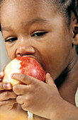 Young girl eating an apple