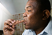 Man eating a bar of chocolate