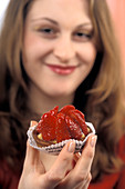 Woman eating a custard dessert
