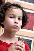 Girl eating a chocolate bar