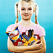 Girl holding crisps and chocolate