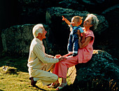 Elderly couple with grandchild in the countryside