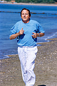Man jogging along beach
