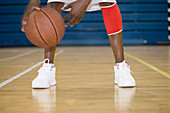 Basketball player bouncing a ball