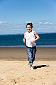 Boy jogging on a beach