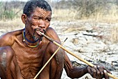 Bushman playing traditional instrument
