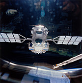 Compton Observatory satellite with Shuttle arm