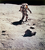 Apollo 16 astronaut collecting lunar rock samples