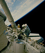Astronaut using snag-type device during EVA