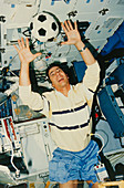 Astronaut playing with football onboard shuttle