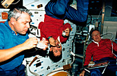 Shuttle astronauts taking a meal