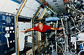 Astronaut James Bagian floating in SLS-1 lab