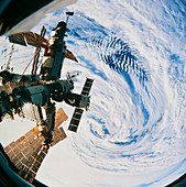 Russian space station Mir over a storm on Earth