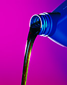 View of lubricating oil pouring from its bottle