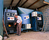 Farmer tending wood chip combustion plant