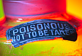 Poison warnign sign on a bottle