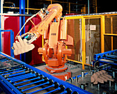Robot arm transferring car engine block moulds