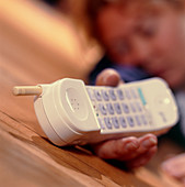 Unconscious woman holding a cordless telephone