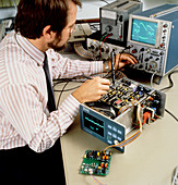 Engineer using an oscilloscope