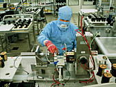 Technician assembling a computer hard drive