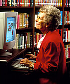 Elderly woman using computer to access the WWW