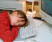 Girl asleep at a home computer