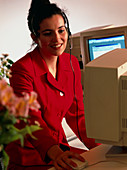 Secretary working at an office computer