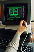 Operator using light pen on Sirisu Microcomputer