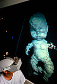 Researcher with 3D ultrasound image of foetus