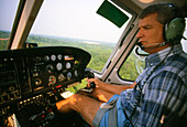 Pilot at controls of a helicopter