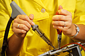 Avionics worker soldering