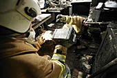 Firefighters in a burnt-out house