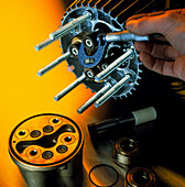 Engineer measures component with micrometer
